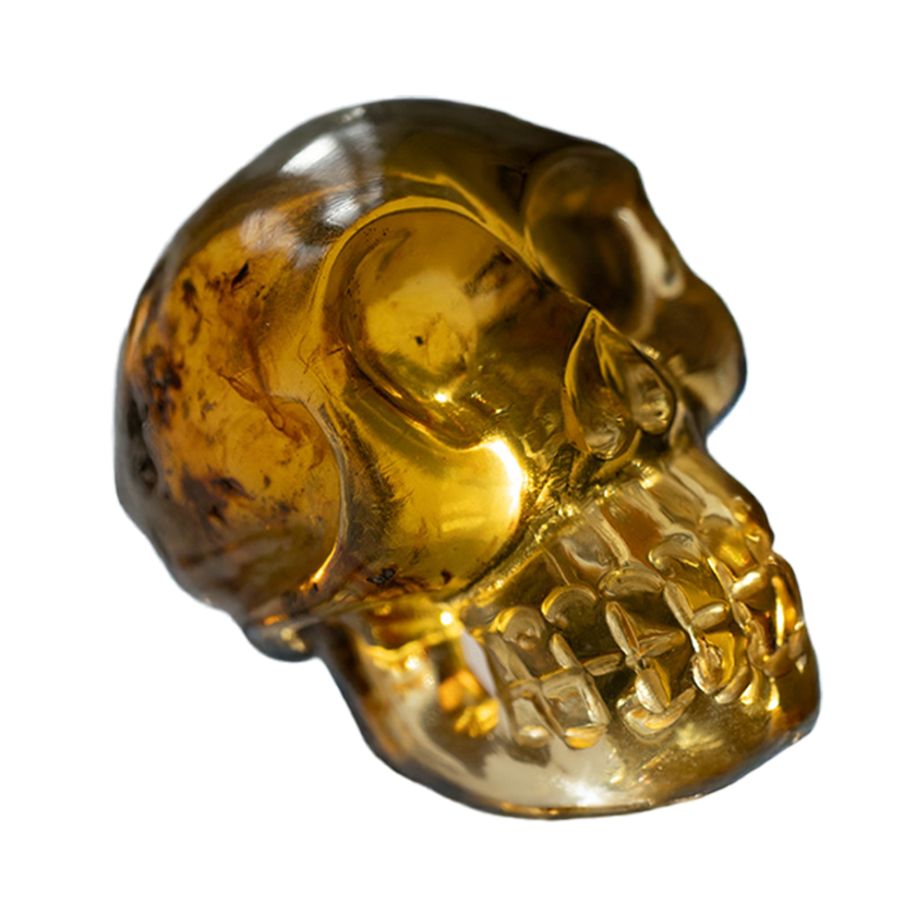 Handmade Dominican blue amber skull carving with natural gemstone