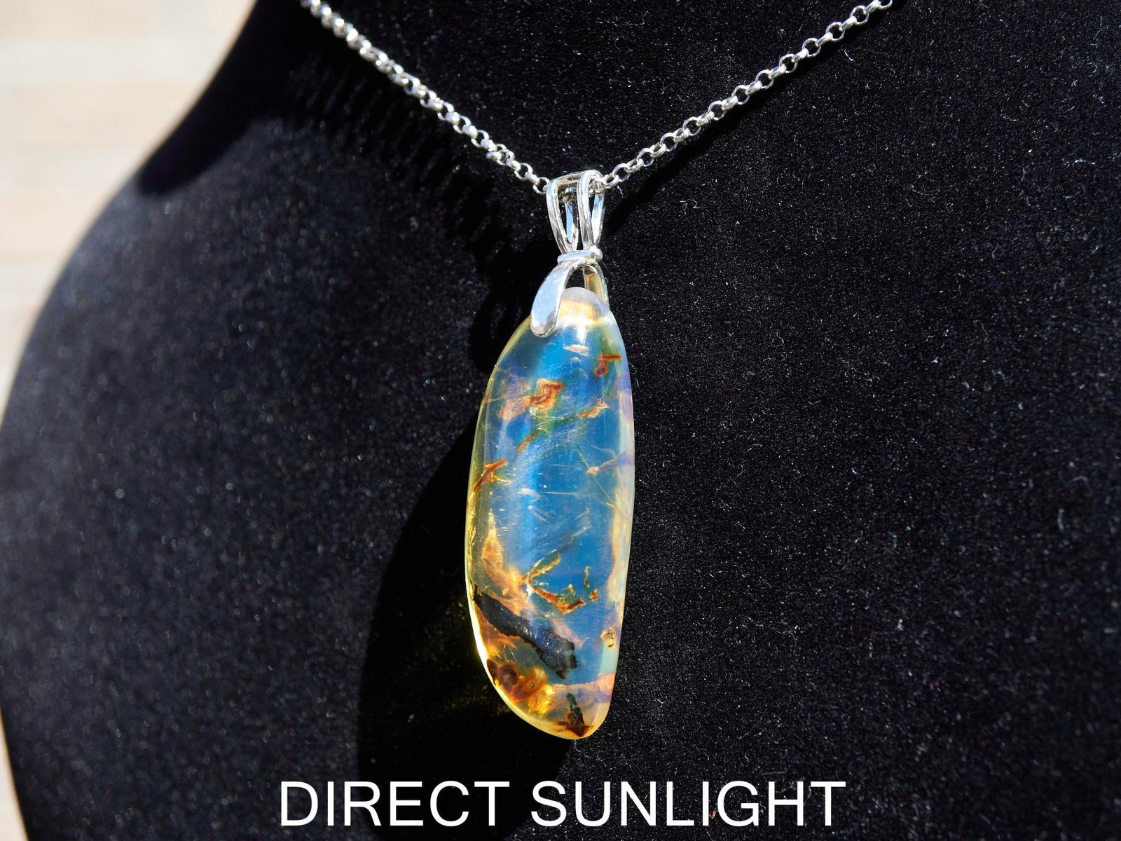 Close-up of a rare Dominican blue amber cabochon showing its unique patterns and inclusions