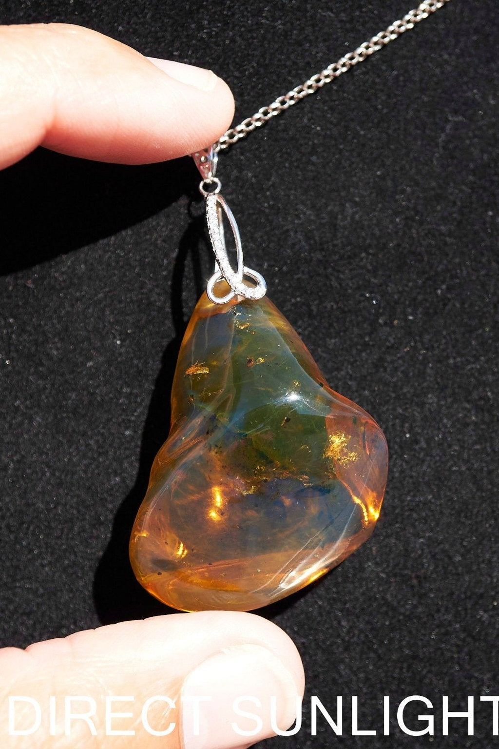 Rare fossilized Dominican amber gemstone with blue tones under natural light