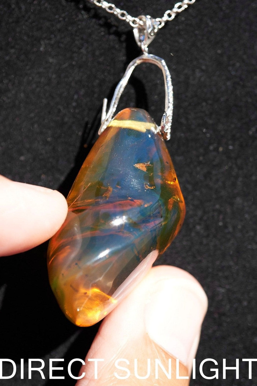 Rare fossilized Dominican amber gemstone with blue tones under natural light
