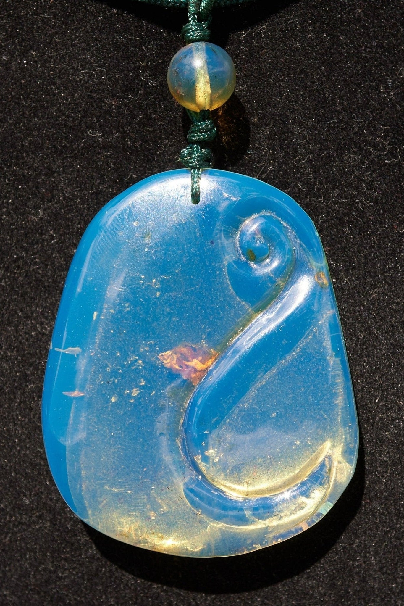 Blue Amber Dominican Pendant Necklace Bell carving shape. - Larimar Creations