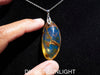 Large blue amber pendant featuring a natural cabochon amber set in sterling silver, showcasing rare Dominican blue hues