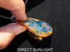 Close-up of a polished Dominican blue amber cabochon glowing under light.