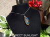 Large blue amber pendant featuring a natural cabochon amber set in sterling silver, showcasing rare Dominican blue hues