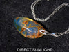 Large blue amber pendant featuring a natural cabochon amber set in sterling silver, showcasing rare Dominican blue hues