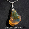 Rare fossilized Dominican amber gemstone with blue tones under natural light