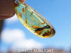 Close-up of a rare Dominican blue amber cabochon showing its unique patterns and inclusions