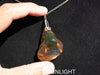 Rare fossilized Dominican amber gemstone with blue tones under natural light