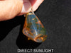 Blue Amber Dominican raw cabochon gemstone with natural vibrant hues