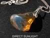 Rare fossilized Dominican amber gemstone with blue tones under natural light