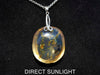 Handcrafted round Dominican blue amber pendant in sterling silver, perfect for gifts