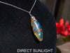 Large blue amber pendant featuring a natural cabochon amber set in sterling silver, showcasing rare Dominican blue hues