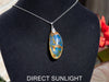 Large blue amber pendant featuring a natural cabochon amber set in sterling silver, showcasing rare Dominican blue hues