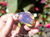 Handcrafted Dominican amber pendant with glowing blue and golden highlights, featuring unique gemstone details and artisan craftsmanship