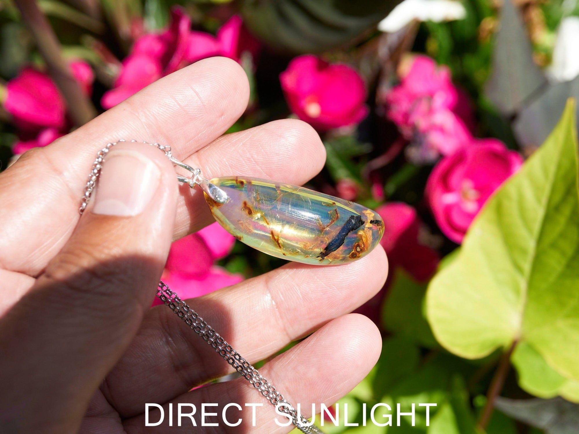 Close-up of a rare Dominican blue amber cabochon showing its unique patterns and inclusions
