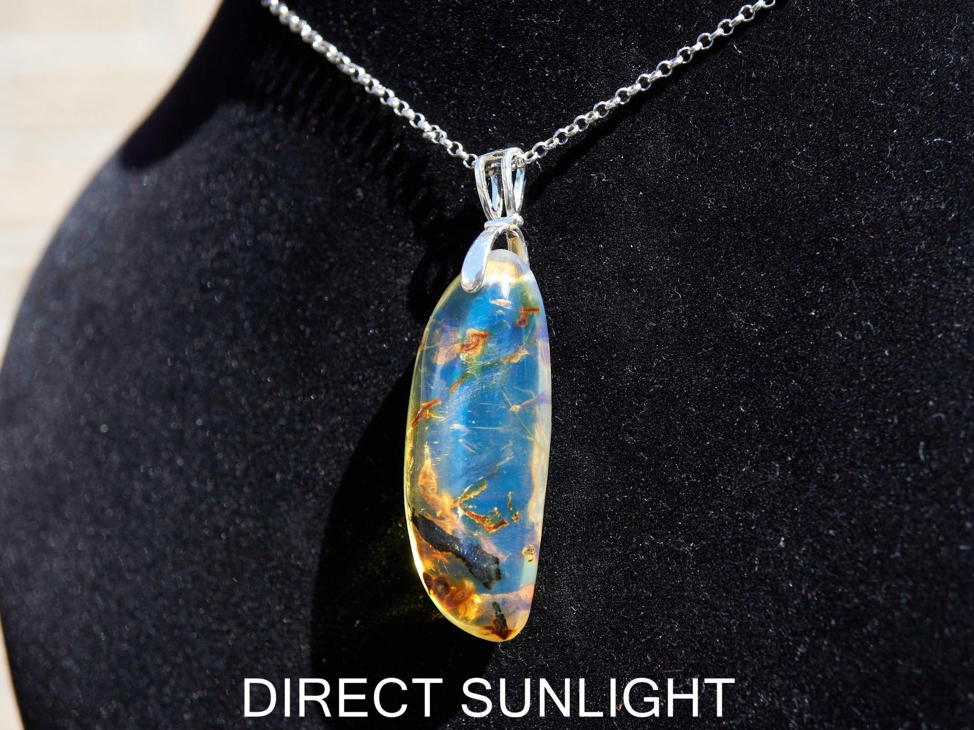 Close-up of a rare Dominican blue amber cabochon showing its unique patterns and inclusions