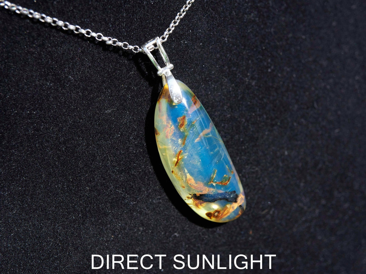 Close-up of a rare Dominican blue amber cabochon showing its unique patterns and inclusions