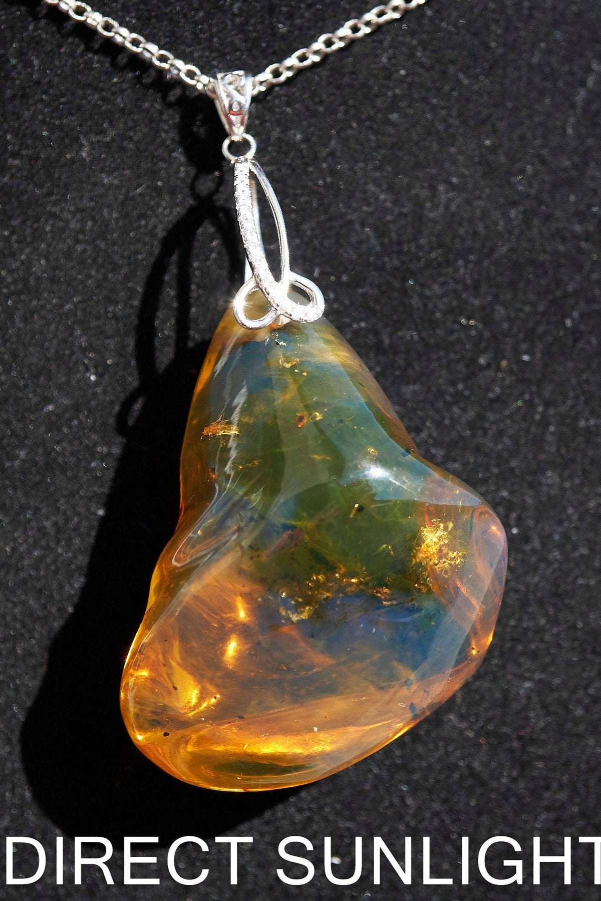 Rare fossilized Dominican amber gemstone with blue tones under natural light
