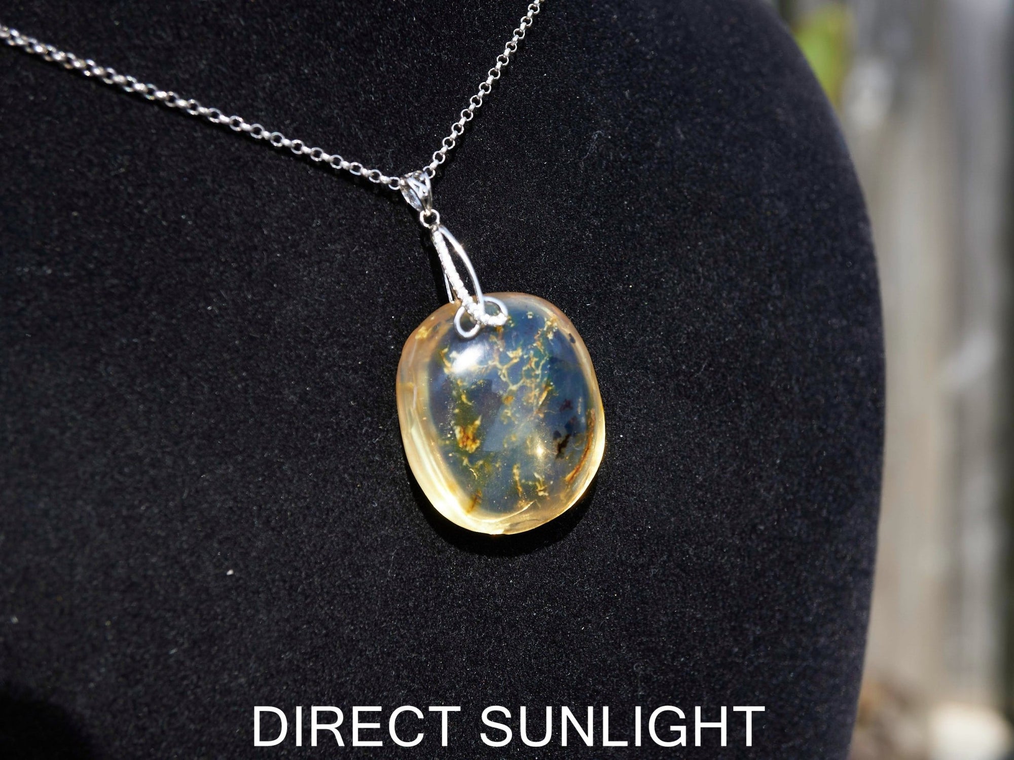 Handcrafted round Dominican blue amber pendant in sterling silver, perfect for gifts