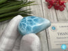 Close-up of a polished natural Larimar cabochon in a smooth teardrop shape, showcasing vibrant oceanic blue hues with subtle white marbling, perfect for jewelry making or as a collectible gemstone