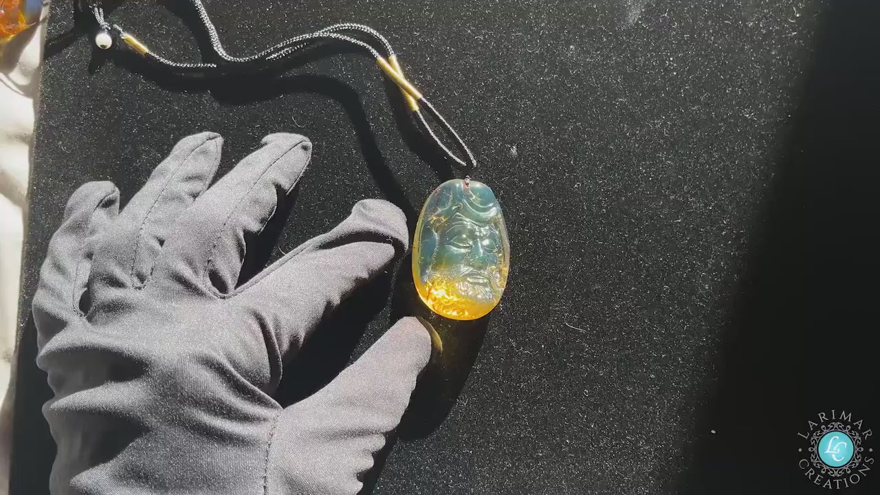 Blue Amber Pendant, Dominican Blue and Green Dharma Amber Bead Necklace,  Dharma Buddha Statue Dominican Amber