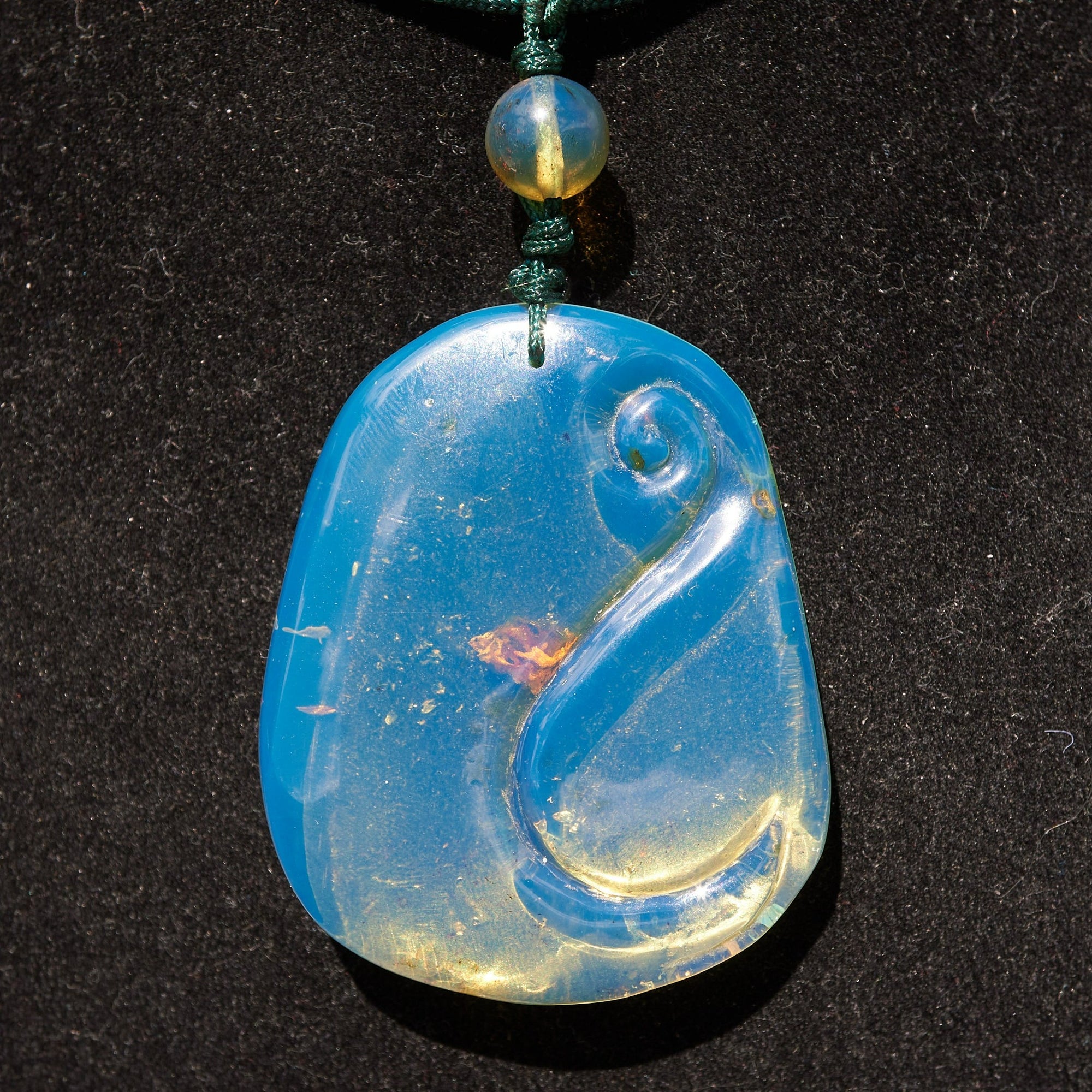 Blue Amber Dominican Pendant Necklace Bell carving shape.