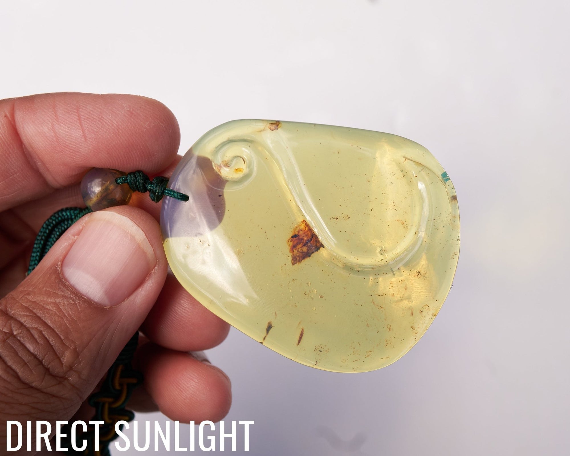 Blue Amber Dominican Pendant Necklace Bell carving shape.