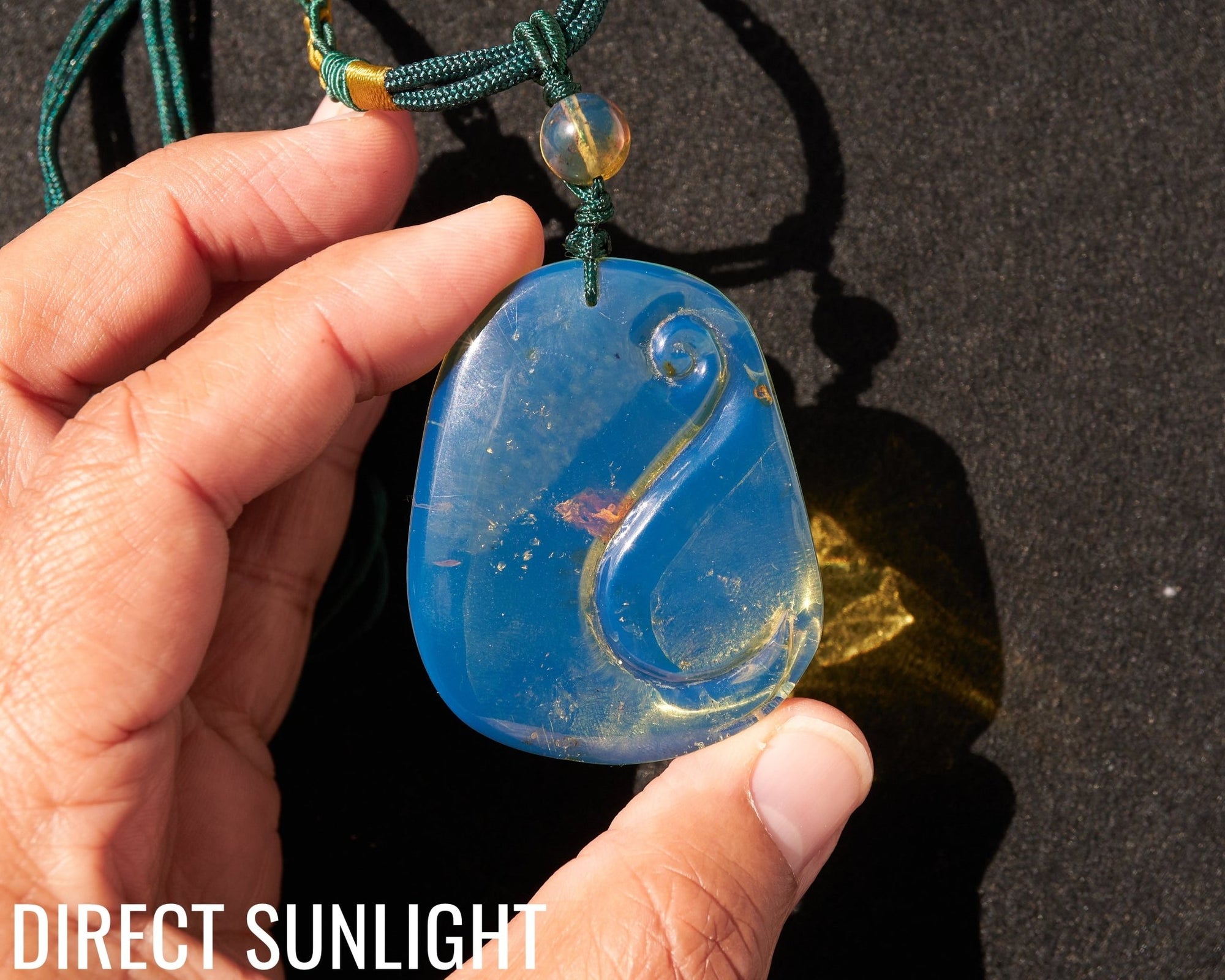 Blue Amber Dominican Pendant Necklace Bell carving shape.