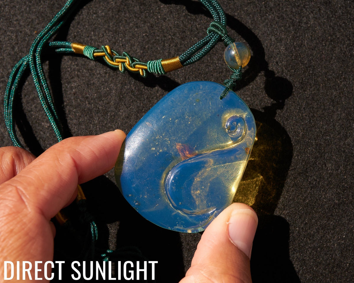 Blue Amber Dominican Pendant Necklace Bell carving shape. - Larimar Creations