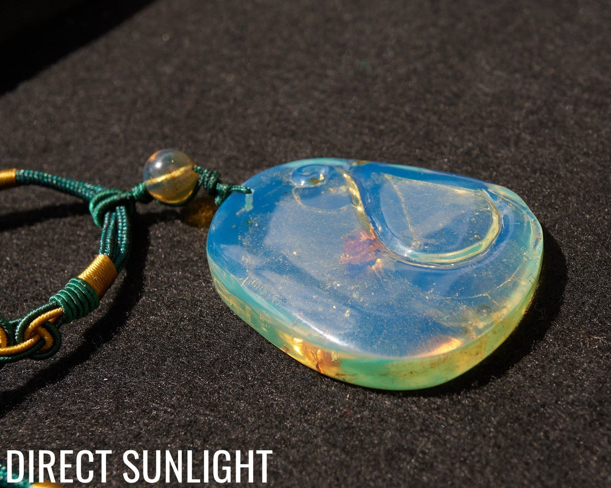 Blue Amber Dominican Pendant Necklace Bell carving shape. - Larimar Creations