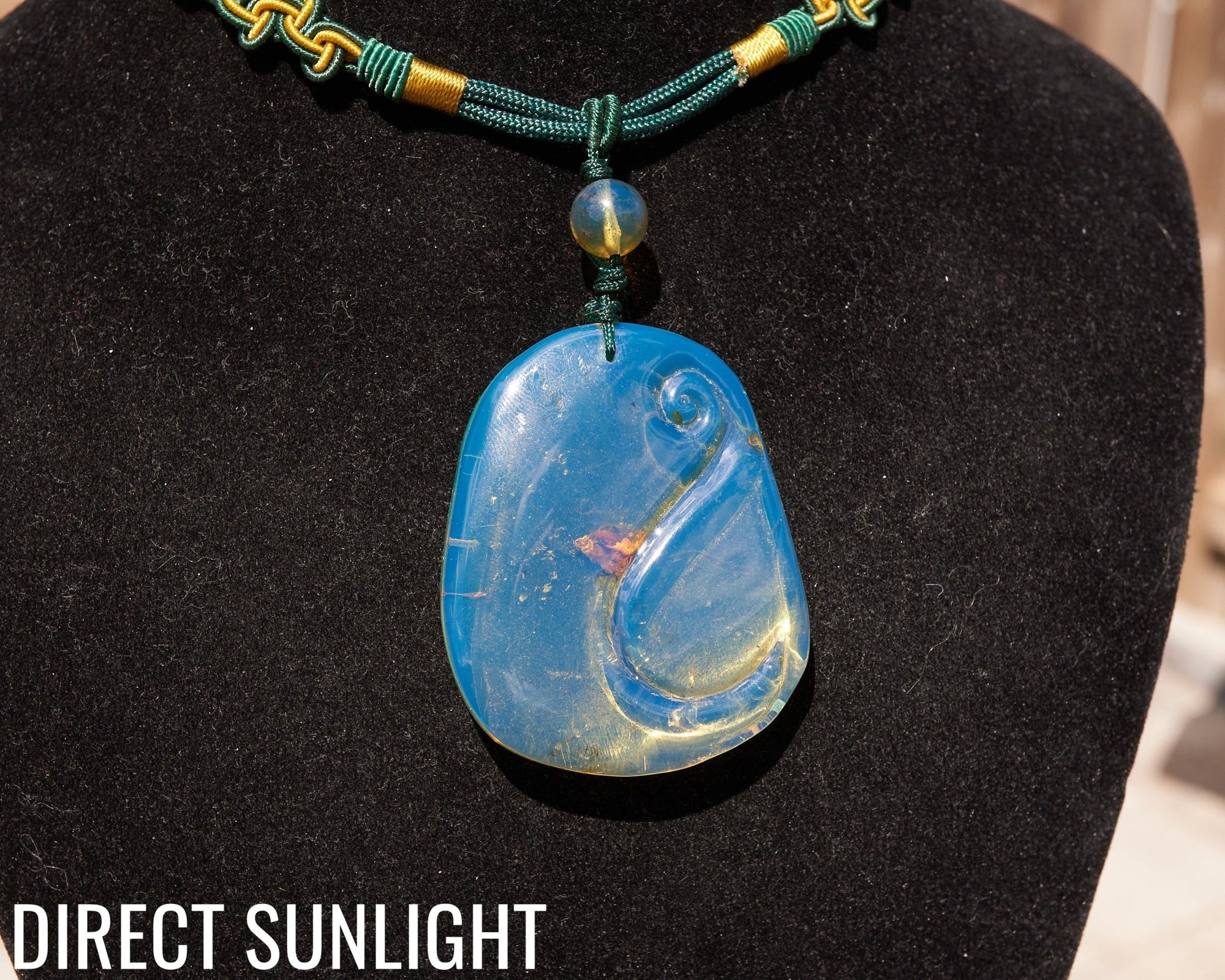 Blue Amber Dominican Pendant Necklace Bell carving shape.